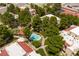 Aerial view showcases a pool nestled amongst red-roofed residences and lush trees, offering a tranquil oasis in the community at 3740 Desert Marina Dr # 3, Laughlin, NV 89029
