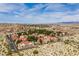 Expansive aerial view showcasing red-roofed townhomes nestled amongst desert foliage, set against a backdrop of mountains and blue skies at 3740 Desert Marina Dr # 3, Laughlin, NV 89029