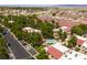 Aerial view of red-roofed residences in a well-maintained community, with mature trees, ample parking, and a refreshing pool area at 3740 Desert Marina Dr # 3, Laughlin, NV 89029