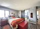 Bedroom with barn door access to bath, a rustic wood bedframe, and colorful decor at 3740 Desert Marina Dr # 3, Laughlin, NV 89029