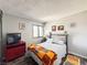 Charming bedroom features a queen bed, accent rug, sunny window, and red entertainment center at 3740 Desert Marina Dr # 3, Laughlin, NV 89029
