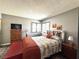 Bedroom boasts wood floors, a rustic wood bedframe, and a sunny window for natural lighting at 3740 Desert Marina Dr # 3, Laughlin, NV 89029
