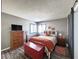 Comfortable bedroom with rustic wood bedframe, wood floors, an accent chest and barn door leading to bath at 3740 Desert Marina Dr # 3, Laughlin, NV 89029