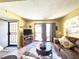 Cozy living room with access to balcony and views of outdoor landscape at 3740 Desert Marina Dr # 3, Laughlin, NV 89029