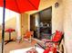 Cozy patio featuring comfortable chairs, a small table, a grill and shade under a red umbrella at 3740 Desert Marina Dr # 3, Laughlin, NV 89029