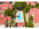 Overhead view of community pool and spa area, nestled among red-roofed residences and mature landscaping, creating a relaxing oasis at 3740 Desert Marina Dr # 3, Laughlin, NV 89029