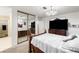 Spacious bedroom with large bed frame, mirrored closet, and a television at 4322 Satinwood Dr, Las Vegas, NV 89147