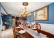 This elegant dining area features a beautiful chandelier and adjacent kitchen views at 4322 Satinwood Dr, Las Vegas, NV 89147