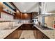 This expansive kitchen features dark cabinets, stainless steel appliances, and granite countertops at 4322 Satinwood Dr, Las Vegas, NV 89147