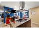 Bright kitchen featuring a granite countertop island, stainless steel hood, and modern appliances at 4322 Satinwood Dr, Las Vegas, NV 89147