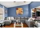 Comfortable living room featuring a large sectional sofa, hardwood floors, and stylish decor at 4322 Satinwood Dr, Las Vegas, NV 89147