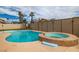 Backyard pool with a connecting hot tub and privacy fencing at 4322 Satinwood Dr, Las Vegas, NV 89147