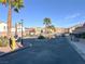 Gated community entrance with palm trees and desert landscaping on a clear day at 4439 Yellow Harbor St, Las Vegas, NV 89129