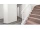 Staircase featuring neutral carpet, white risers and banister, and wood-look floors at 4439 Yellow Harbor St, Las Vegas, NV 89129