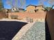 Backyard featuring brick-paved area, rock garden, privacy wall, and patio set at 486 Stonegate Meadow Ave, Las Vegas, NV 89178