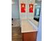 Bathroom vanity with a large mirror and solid surface countertop at 486 Stonegate Meadow Ave, Las Vegas, NV 89178
