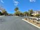 View of the gated community entrance with desert landscaping, featuring sturdy iron gates and stone pillars on a clear day at 486 Stonegate Meadow Ave, Las Vegas, NV 89178