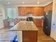 Spacious kitchen featuring granite countertops, a center island, and modern appliances at 486 Stonegate Meadow Ave, Las Vegas, NV 89178
