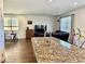 Open kitchen featuring granite island with sink overlooking the living space at 486 Stonegate Meadow Ave, Las Vegas, NV 89178