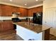 Spacious kitchen featuring granite countertops, a center island, and modern appliances at 486 Stonegate Meadow Ave, Las Vegas, NV 89178