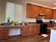 Well-lit kitchen with wooden cabinets, granite countertops, and a gas range at 486 Stonegate Meadow Ave, Las Vegas, NV 89178