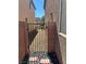 View of a side yard between two houses, featuring a metal gate and rock landscape at 486 Stonegate Meadow Ave, Las Vegas, NV 89178