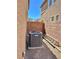 Side yard featuring Lennox air conditioning unit, rock landscape, and ladder at 486 Stonegate Meadow Ave, Las Vegas, NV 89178