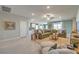 Bright living room featuring a comfortable sofa, natural light, and seamless flow to other living spaces at 498 Copper Falcon Ave, Henderson, NV 89011