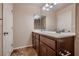 Well-lit bathroom featuring a double sink vanity with ample storage and tile flooring at 6075 Belvedere Canyon Ave, Las Vegas, NV 89139
