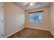 Cozy bedroom features neutral walls, carpet and a ceiling fan at 6075 Belvedere Canyon Ave, Las Vegas, NV 89139