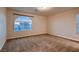 Spacious bedroom with neutral carpet and arched window providing ample natural light at 6075 Belvedere Canyon Ave, Las Vegas, NV 89139