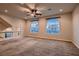 Bright bonus room with neutral carpet, arched windows, and a modern ceiling fan at 6075 Belvedere Canyon Ave, Las Vegas, NV 89139