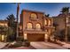 Elegant two-story home with a two car garage, well-manicured landscaping and decorative stone entryway at 6075 Belvedere Canyon Ave, Las Vegas, NV 89139