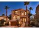 Attractive two-story home with stone accents, arched windows, balconies and steps leading to the entryway at 6075 Belvedere Canyon Ave, Las Vegas, NV 89139