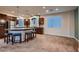 Spacious kitchen featuring stainless steel appliances, dark wood cabinets and a large granite island with seating at 6075 Belvedere Canyon Ave, Las Vegas, NV 89139