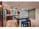 Well-lit kitchen with stainless appliances, center island and adjacent living space perfect for entertaining at 6075 Belvedere Canyon Ave, Las Vegas, NV 89139