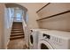 Laundry room with stairs and front load machines at 6075 Belvedere Canyon Ave, Las Vegas, NV 89139