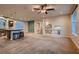 Open concept living room featuring neutral carpet, high ceilings, and access to the kitchen at 6075 Belvedere Canyon Ave, Las Vegas, NV 89139