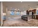 Expansive living room with carpet flooring, neutral walls and large arched windows offering plenty of light at 6075 Belvedere Canyon Ave, Las Vegas, NV 89139