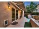 Backyard patio with a partial awning, sliding glass doors, and a small elevated pool with tiered waterfall at 6075 Belvedere Canyon Ave, Las Vegas, NV 89139