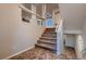 Carpeted staircase with decorative wall cutouts, tile landing, and natural light at 6075 Belvedere Canyon Ave, Las Vegas, NV 89139