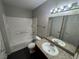 A well-lit bathroom with a tub and shower combination and granite countertop vanity at 6800 E Lake Mead Blvd # 1018, Las Vegas, NV 89156