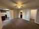 Spacious bedroom with neutral carpeting, a ceiling fan, and access to a bathroom and closet at 6800 E Lake Mead Blvd # 1018, Las Vegas, NV 89156