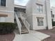 Two-story condo featuring stairs to the unit with desert landscaping at 6800 E Lake Mead Blvd # 1018, Las Vegas, NV 89156