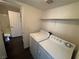 A laundry room featuring a washer, dryer, and storage shelf above at 6800 E Lake Mead Blvd # 1018, Las Vegas, NV 89156