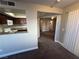 Cozy living room showcasing neutral paint, carpeting, and a pass-through to the kitchen at 6800 E Lake Mead Blvd # 1018, Las Vegas, NV 89156