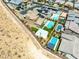 Modern home features a pool, sports court, desert landscape, and neighboring community at 7222 Pulsar Mesa Ct, Las Vegas, NV 89148
