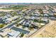 Community aerial featuring modern homes with desert landscaping, solar panels, and pool, located near entertainment and amenities at 7222 Pulsar Mesa Ct, Las Vegas, NV 89148