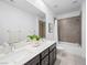 Bright bathroom featuring dual sinks and a shower with a tub offers maximum comfort at 7222 Pulsar Mesa Ct, Las Vegas, NV 89148