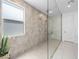 A modern bathroom features a large, frameless glass shower with multiple shower heads and neutral tile at 7222 Pulsar Mesa Ct, Las Vegas, NV 89148
